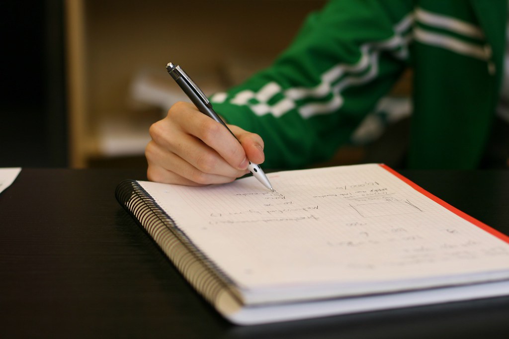 Hand writing notes during a brainstorming session